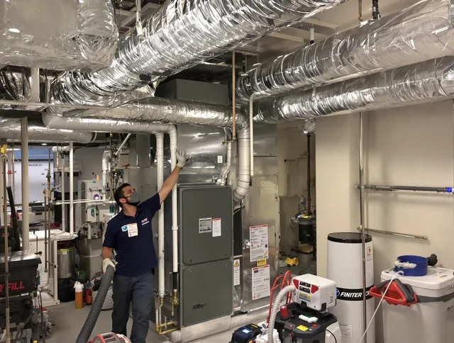 Glocester Air Duct Cleaning specialist performing thorough furnace duct cleaning in a Glocester residence