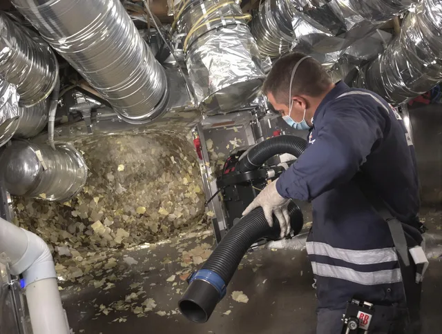 Glocester Air Duct Cleaning specialist operating negative pressure cleaning equipment for thorough duct maintenance in Glocester