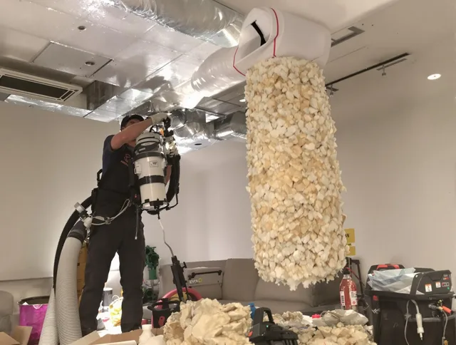 Glocester Air Duct Cleaning technician performing precision vacuum insulation removal in a residential property in Glocester